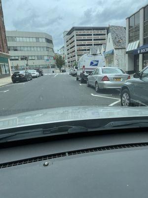 US POSTAL TRUCK PARKED IN A HANDICAP SPOT ON THE RIGHT SIDE