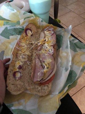 Subway club with extra onion and extra cheese.