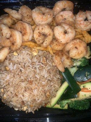 Shrimp with fried rice and vegetables.