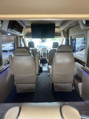 Seven passenger luxury transit van TVs