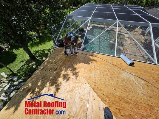 Removal of all old layers of the roof to make sure the wood deck is without water damage before installing a new metal roof.