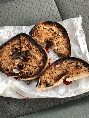 Burnt blueberry bagel with butter - not edible