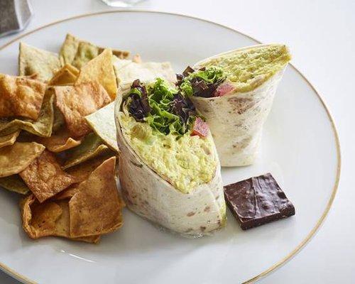 Curry Chicken salad with lettuce & tomato on Whole Wheat bread or herb wrap. Served with house made chips and chocolate bark.