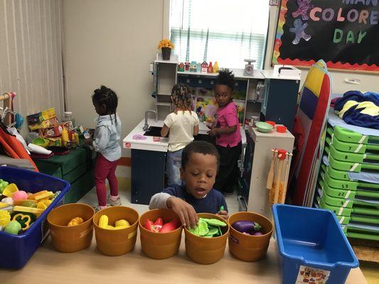 Children engaged in "hands-on learning stations"  and "manipulative centers."  Learning through PLAY.