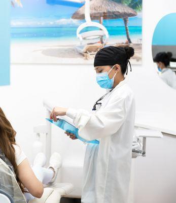 Dental Hygienist going over Deep cleaning post op care instructions with patient.