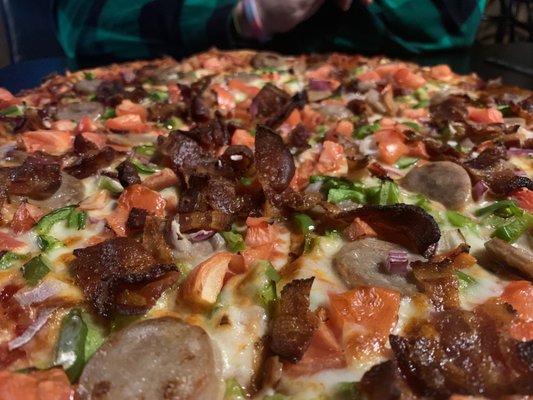 Bacon, Irish sausage, green peppers and onion and tomato pizza