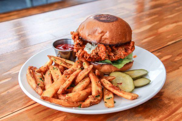 Buffalo Chicken Sandwich with fires and housemade pickles