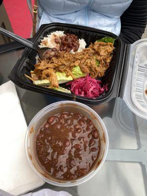 Carne and rice (w/ roasted pork) and side of "critically acclaimed" vegetarian black beans.