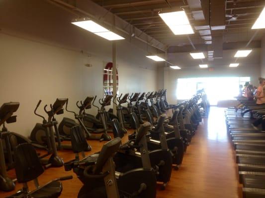 Cardio room with 12 treadmills 17 elipticals 12 bikes and 6 50 inch tvs for all your workout needs