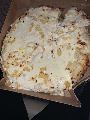 A disgusting raw pizza with a while can of sauce