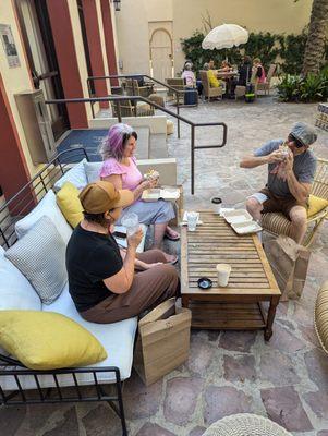 bbaddies enjoying their breakfast burritos in the courtyard.