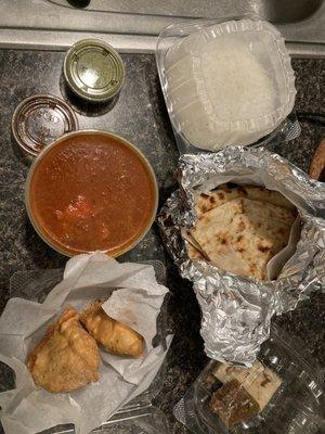 Chicken vindaloo, butter naan, vegetable samosas, chutney and barfi.