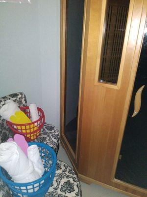 This is the sauna room with the pretty baskets stocked with a towel robe and  disposable flip flops.