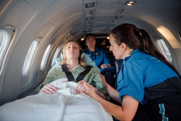 Aircraft interior; executive quality feel, padded stretcher bed, two medical crew members, family member, holistic medical care