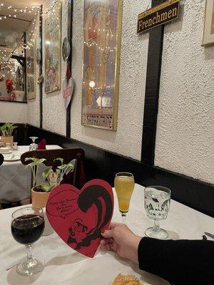 The Valentines Day drinks menu is on the other side of the heart and included the glasses of Merlot and Peach Bellini on the table.