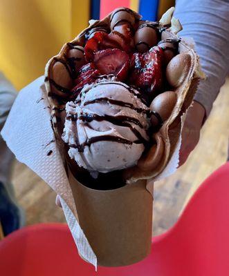 Crispy waffle-like shell, with strawberries, strawberry ice cream, and chocolate syrup