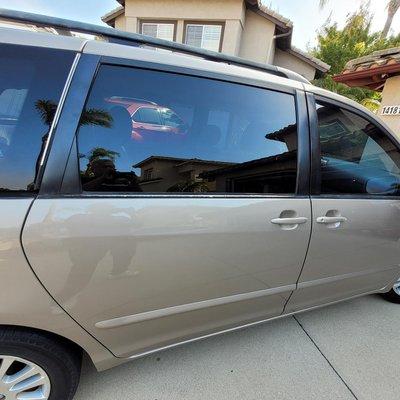 Passenger side sliding door had pealing clear coat and faded paint.