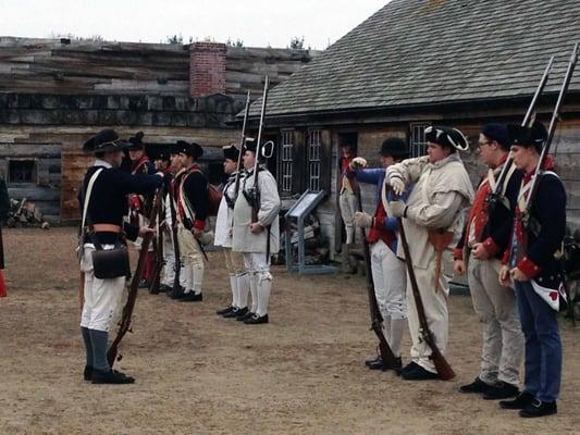 Reenactors mustering in the parade ground inside the fort