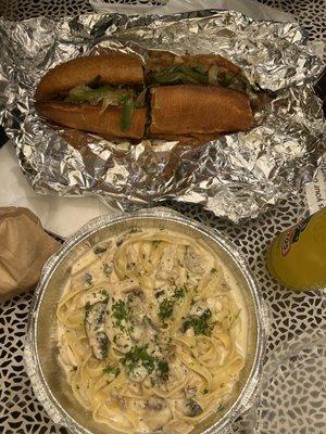 Philly Cheesesteak sandwich and fettuccine Alfredo with chicken and mushroom. Soooooo good