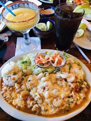 Shrimp dish with a side of salad and white rice mixed with vegetables.