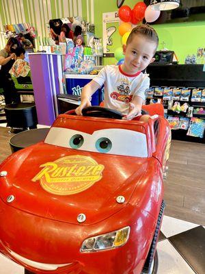 Having the time of his life in his Lightening McQueen car!