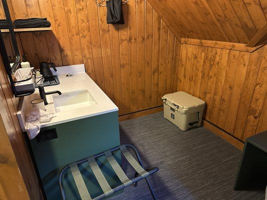 The sink is in the room, also comes with a microwave, a hair dryer, a dorm fridge, and a bear box(!), which we did not use.