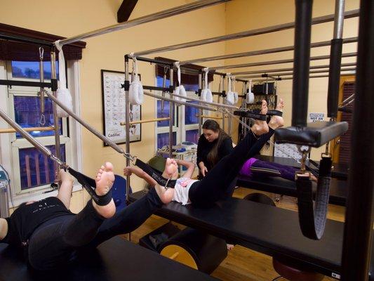 Group Cadillac classes include the hanging and traction exercises of the Pilates Repertoire