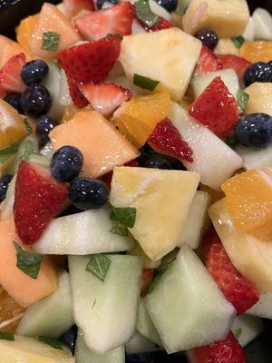 A fruit salad with citrus and mint.