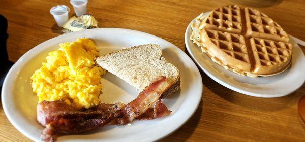 Bacon, scrambled eggs, wheat toast, and belgian waffle.