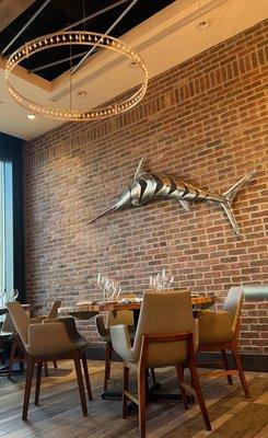 Interior of the restaurant- Rustic Brick Wall with a big metallic fish decor