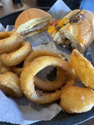 Steak/cheese and chicken sandwich with onion rings