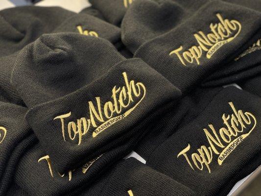 Top Notch embroidered logo on multiple black beanies.