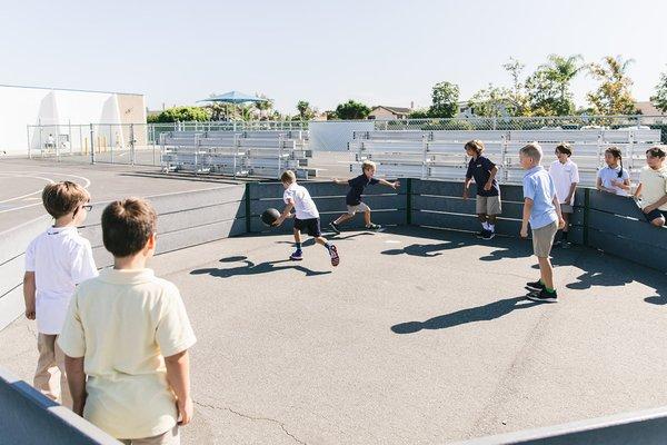 Gaga Ball on the back play area at recess.