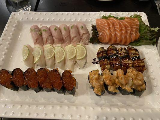 Hamachi nigiri, salmon sashimi, escolar nigiri, eel nigiri, ikura nigiri, and chopped spicy scallop nigiri