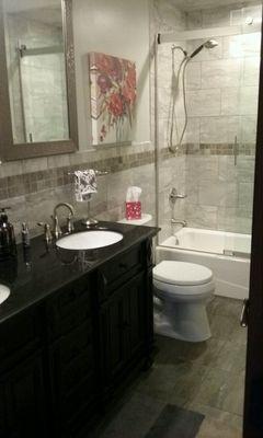 Complete bathroom renovation: tile floor, large wall tiles, and new cast iron tub