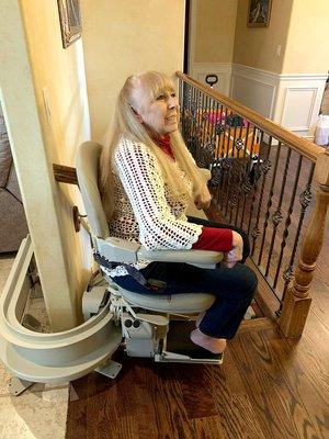 Bruno curved stair lift installed inside a happy customer's home.