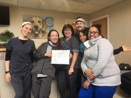 Meet our team! Here we are with a photo from one of our families who treated their pet for cancer.