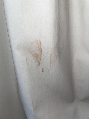 Reddish brown stain on the curtain