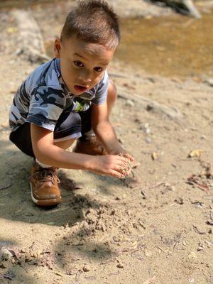 Playing in the sand by the creek.