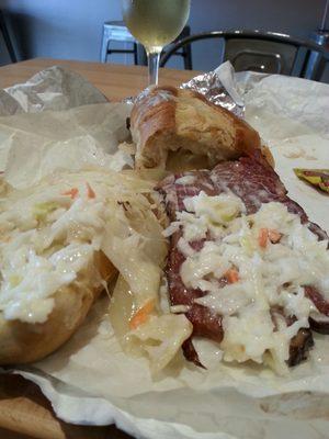 Beef brisket sandwich - open so you can see the cheese (melted) and coleslaw.