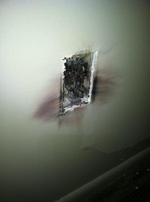 This is what a lightning strike to the electrical system can do. It blew apart the wall and burned up several tv's & computer...