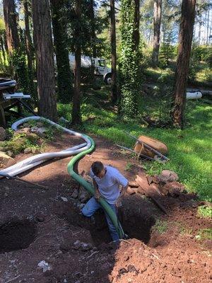 Pumping a residential septic tank.