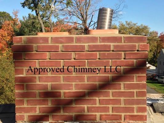 Newly Rebuild Chimney with proper liners installed to accommodate the fireplace flue and heating appliances.