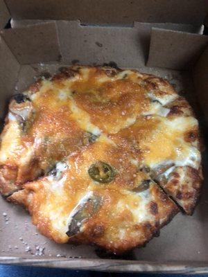 Mushroom and cheddar cheese pizza with no sauce (and 1 jalapeño)