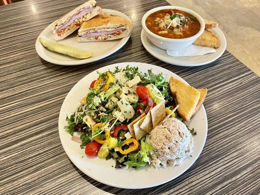 Italian chop salad (front), muffuletta (top left), bowl of Italian bean soup (top right)