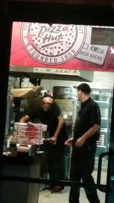 Talking on cell phone while handling pizzas!!!