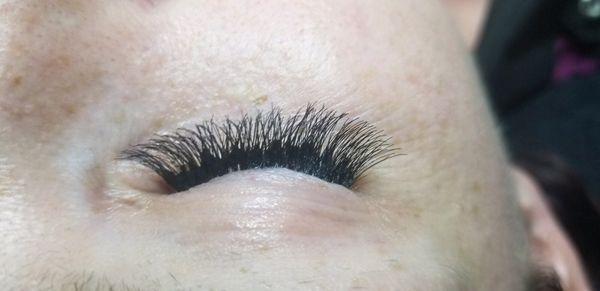 Eye lash extensions should look natural just a huge amount of this horrible glue whatever it was!