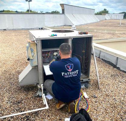 Josh Craig repairing AC unit