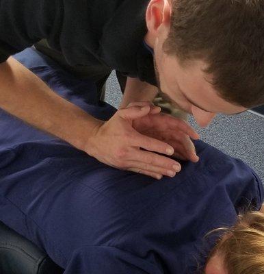 Thoracic spine adjustment to relieve mid back pain, shoulder pain, and other issues with movement of the middle of your back.