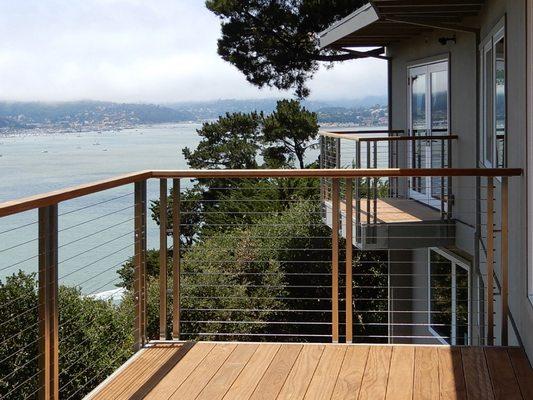 Custom-designed double railing posts give a unique railing look to this deck. The client chose the outdoor railing for the balcony & deck.